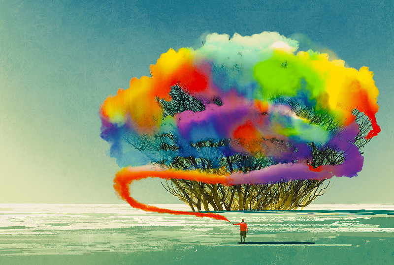 男子用彩色烟雾弹画了一棵抽象的树图片下载